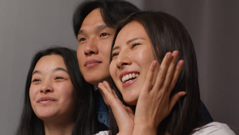 Group-Of-Friends-In-Photo-Booth-Having-Fun-Posing-For-Portrait-And-Pulling-Faces